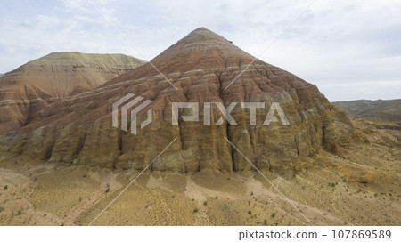 Colorful high mountains and a canyon made of clay Colorful high mountains and a canyon made of clay 107869589