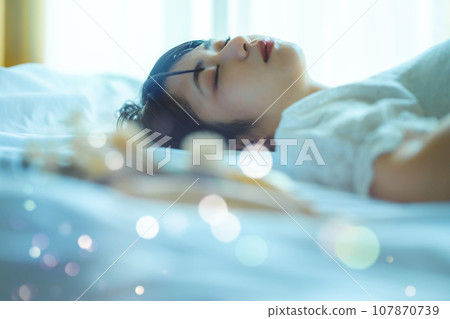 Portrait of a woman lying on the bed Portrait of a woman lying on the bed 107870739