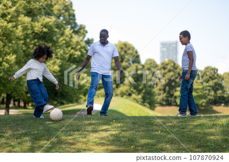 Happy family spending time together in a park and looking enjoyed 107870924