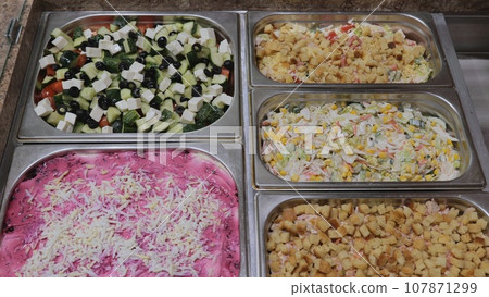 Fast food bistro, salads in patches on display, Charity kitchen, fast food cafe, colorful salads on display Fast food bistro, salads in patches on display, Charity kitchen, fast food cafe, colorful salads on display 107871299
