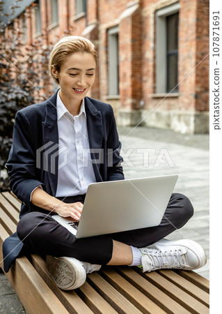 Young woman working and looking involved and focused 107871691