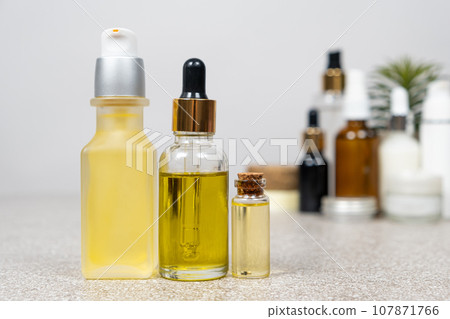 Natural oils for hair and skin care. Cosmetics in glass jars, eco-friendly products. 107871766