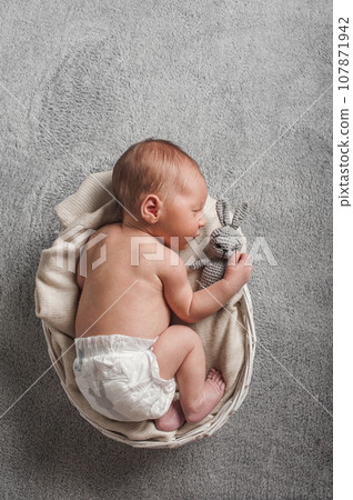 Newborn 3 weeks sleeping with rabbit toy close up. Baby care, colic, teething, healthy sleep.. Newborn 3 weeks sleeping with rabbit toy close up. Baby care, colic, teething, healthy sleep.. 107871942