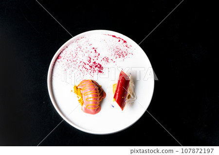 Italian Sicilian cannolo dessert closeup on white plate macro with crust and ricotta cheese 107872197