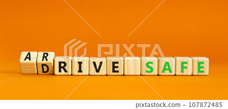 Drive and arrive safe symbol. Concept words Drive safe Arrive safe on wooden blocks. Beautiful orange table orange background. Business drive and arrive safe concept. Copy space. 107872485