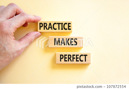 Practice makes perfect symbol. Concept words Practice makes perfect on wooden block. Beautiful white table white background. Businessman hand. Business practice makes perfect concept. Copy space. Practice makes perfect symbol. Concept words Practice makes perfect on wooden block. Beautiful white table white background. Businessman hand. Business practice makes perfect concept. Copy space. 107872554