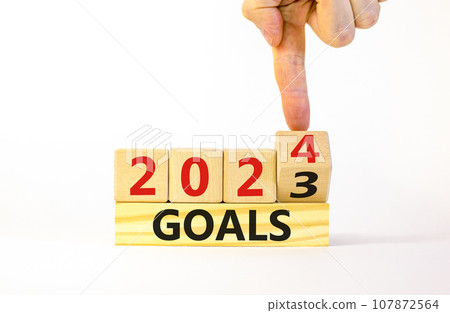 Planning 2024 goals new year symbol. Businessman turns a wooden cube and changes words Goals 2023 to Goals 2024. Beautiful white background, copy space. Business 2024 goals new year concept. Planning 2024 goals new year symbol. Businessman turns a wooden cube and changes words Goals 2023 to Goals 2024. Beautiful white background, copy space. Business 2024 goals new year concept. 107872564