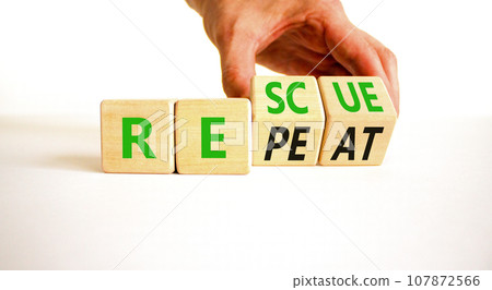 Rescue and repeat symbol. Concept words Rescue Repeat on wooden block. Beautiful white table white background. Businessman hand. Business rescue and repeat concept. Copy space. 107872566