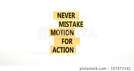 Mistake or action symbol. Concept words Never mistake motion for action on wooden blocks. Beautiful white table white background. Business mistake or action concept. Copy space. Mistake or action symbol. Concept words Never mistake motion for action on wooden blocks. Beautiful white table white background. Business mistake or action concept. Copy space. 107872582