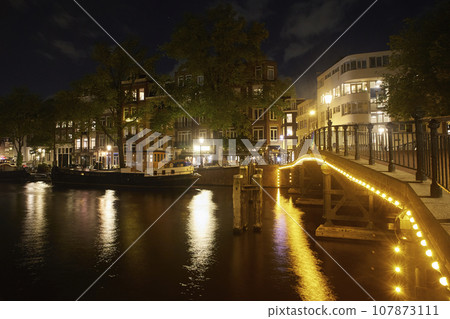 Majestic Amsterdam at night. Summer city landscape. Majestic Amsterdam at night. Summer city landscape. 107873111