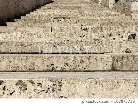 Old tufa stairs up closeup. Ancient steps 107873739