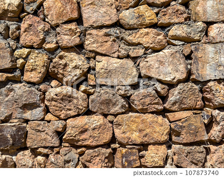 Old stone wall background. Ancient stonewall texture Old stone wall background. Ancient stonewall texture 107873740