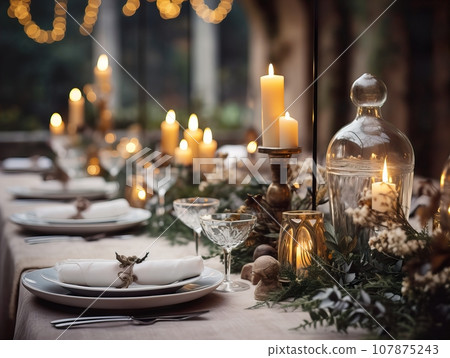 Winter holiday season festive dining table decoration with candles and beautiful tableware, elegant table decor 107875243