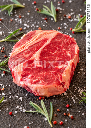 Uncooked rib eye steak 107875286