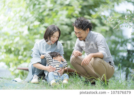 Happy Asian (Japanese) family playing in the park Image of spring and summer in the fresh green season Happy Asian (Japanese) family playing in the park Image of spring and summer in the fresh green season 107876879