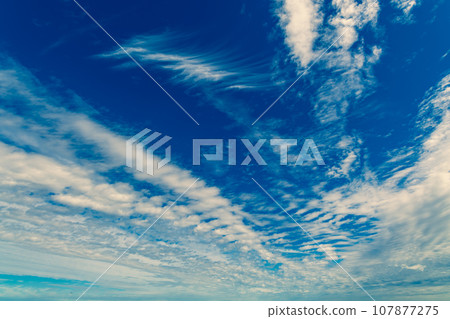 Clouds flowing in the blue sky of autumn b-4 Warm colors added Clouds flowing in the blue sky of autumn b-4 Warm colors added 107877275