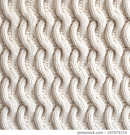 Knitted white texture with a pattern. White knitted fabric as background. Knitted white texture with a pattern. White knitted fabric as background. 107879154