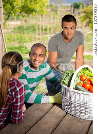 Good friends have conversation at table in the backyard 107879350