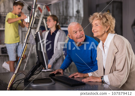 Grandparents and teenagers trying to get out of an escape room stylized under laboratory Grandparents and teenagers trying to get out of an escape room stylized under laboratory 107879412