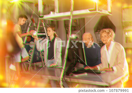 Family is using PC in time having fun together in lost labroom 107879991