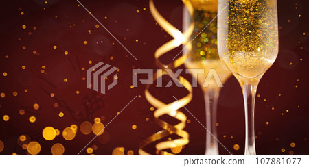 Two New Year's glasses of champagne with highlights on a colored background 107881077