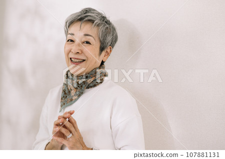 An elegant Japanese woman with gray hair who puts her hands together An elegant Japanese woman with gray hair who puts her hands together 107881131