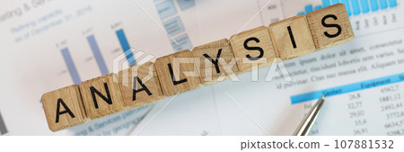Word Analysis made of wooden cubes on accounting papers 107881532