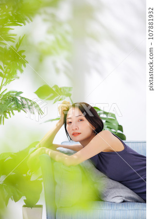 A woman relaxing on the sofa A woman relaxing on the sofa 107881932
