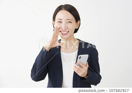 Business woman cheering with a smartphone, white background 107882927