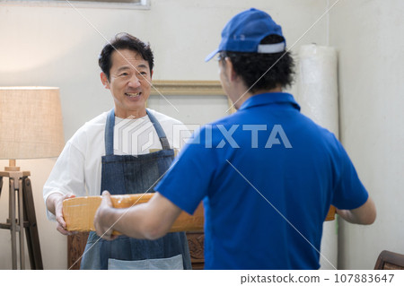 A man who delivers parcels or parcels A man who delivers parcels or parcels 107883647