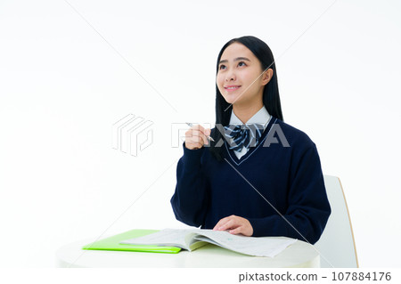 Female student studying for entrance exam 107884176