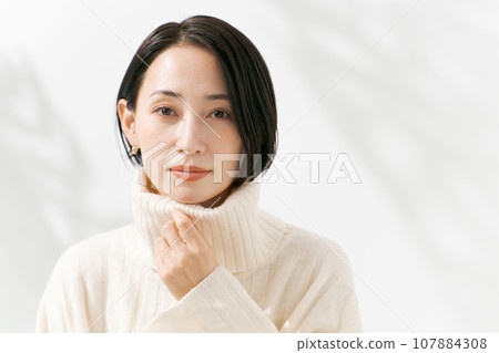 A woman in a white sweater A woman in a white sweater 107884308