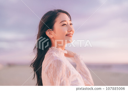 Beauty image of a woman bathed in the sunset 107885006