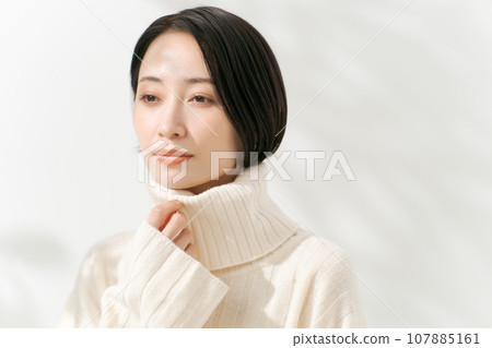 A woman in a white sweater A woman in a white sweater 107885161