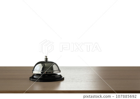 Hotel service bell on wood counter isolated on white background Hotel service bell on wood counter isolated on white background 107885692