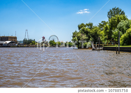 Boat tour on the Parana Delta, Tigre, Buenos Aires, Argentina. Palm trees, construction site of modern brick house. Boat tour on the Parana Delta, Tigre, Buenos Aires, Argentina. Palm trees, construction site of modern brick house. 107885758