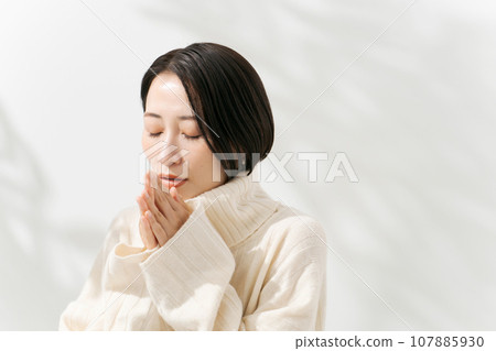 A woman in a white sweater A woman in a white sweater 107885930