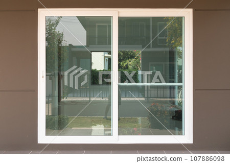 modern sliding glass door frame outside the house 107886098