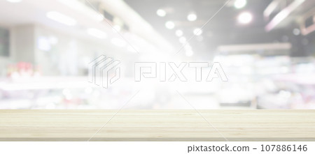 Wood table top with supermarket grocery store blurred background with bokeh light for product display 107886146