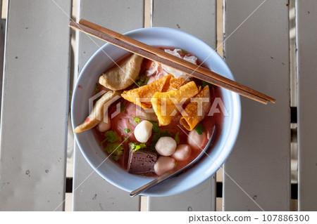 Large Yen Ta Fo Noodles on the Dining Table for Lunch. Large Noodles in Pink Soup, Asian Cousine Large Yen Ta Fo Noodles on the Dining Table for Lunch. Large Noodles in Pink Soup, Asian Cousine 107886300
