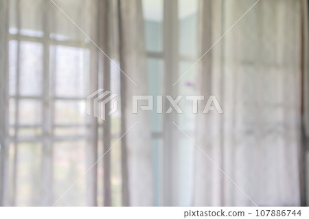 window curtain with green garden abstract blur background 107886744