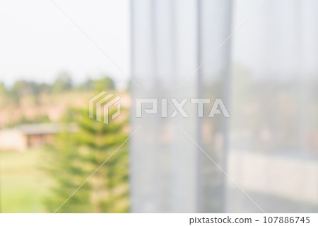 window curtain with green garden abstract blur background 107886745