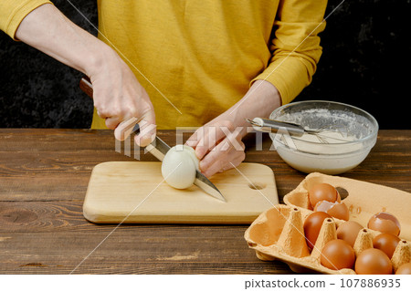 Man cutting white onion with knife Man cutting white onion with knife 107886935