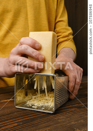 Close up view of grating cheese Close up view of grating cheese 107886948