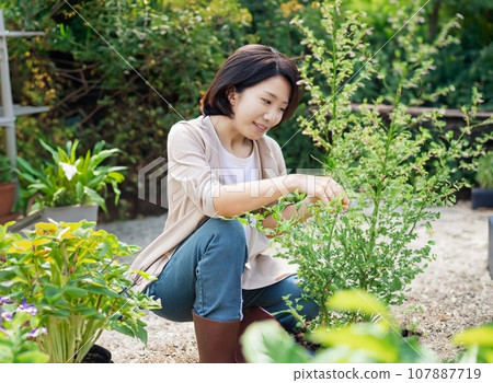 AI-generated image of a young woman doing gardening in her home garden 107887719
