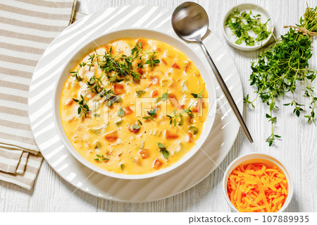 Beer cheese soup with vegetables and thyme 107889935