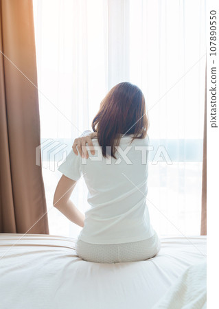 Woman having Shoulder and Neck pain during sitting on bed at home. Muscle painful due to Myofascial pain syndrome and Fibromyalgia, rheumatism, Scapular pain, Cervical Spine. Waking and Health concept Woman having Shoulder and Neck pain during sitting on bed at home. Muscle painful due to Myofascial pain syndrome and Fibromyalgia, rheumatism, Scapular pain, Cervical Spine. Waking and Health concept 107890550