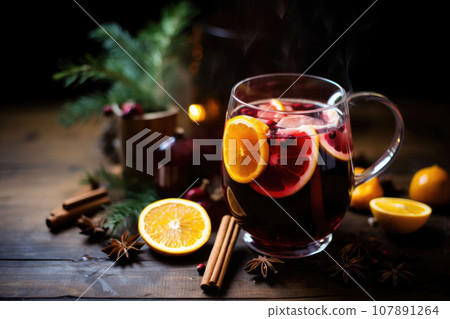 Mulled red wine with spices and citrus fruits. Traditional hot drink at Christmas time. Generative AI 107891264