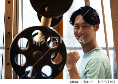Young man training his body at a personal gym Young man training his body at a personal gym 107891305