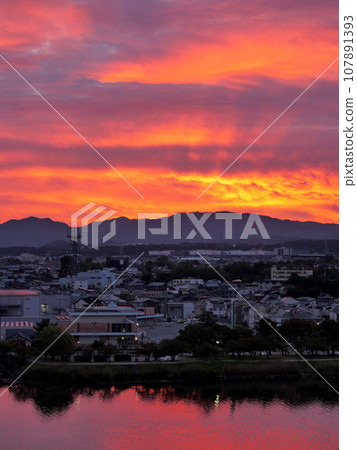 A beautiful sunrise dyed fiery red 107891393